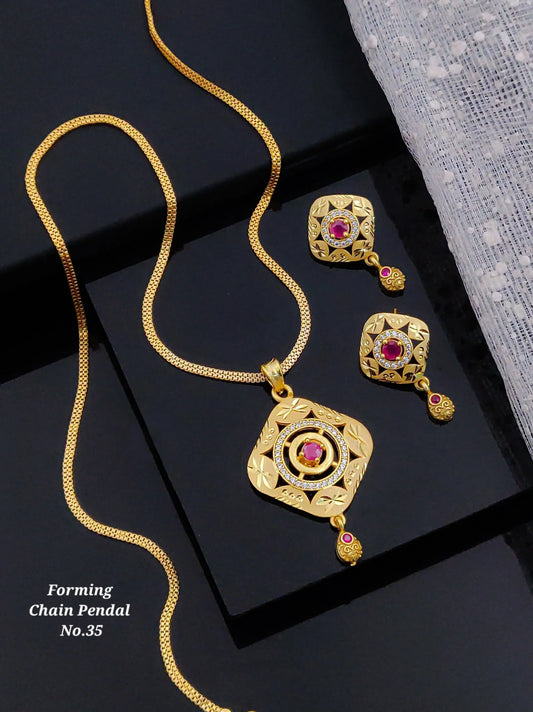 Gold chain necklace with square pendant and matching earrings featuring red gemstones and intricate floral designs