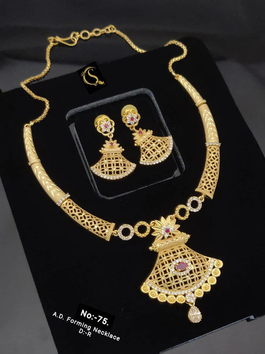 Gold A.D. forming necklace and matching earrings set with intricate lattice design and pink gemstone accents